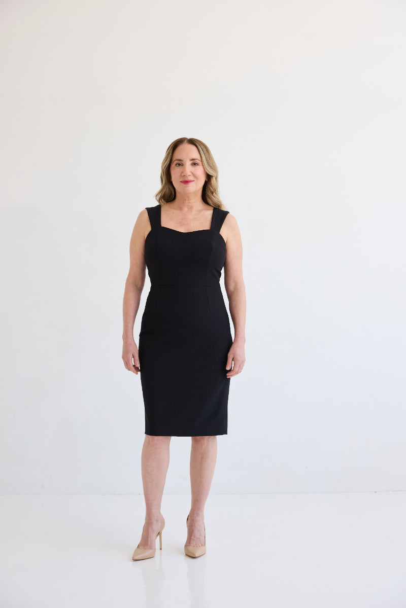 The Maverick Dress, Dress with sweetheart style neckline, sleeveless with shoulder straps, knee length, and back slit for ample movement. Dress in color black.