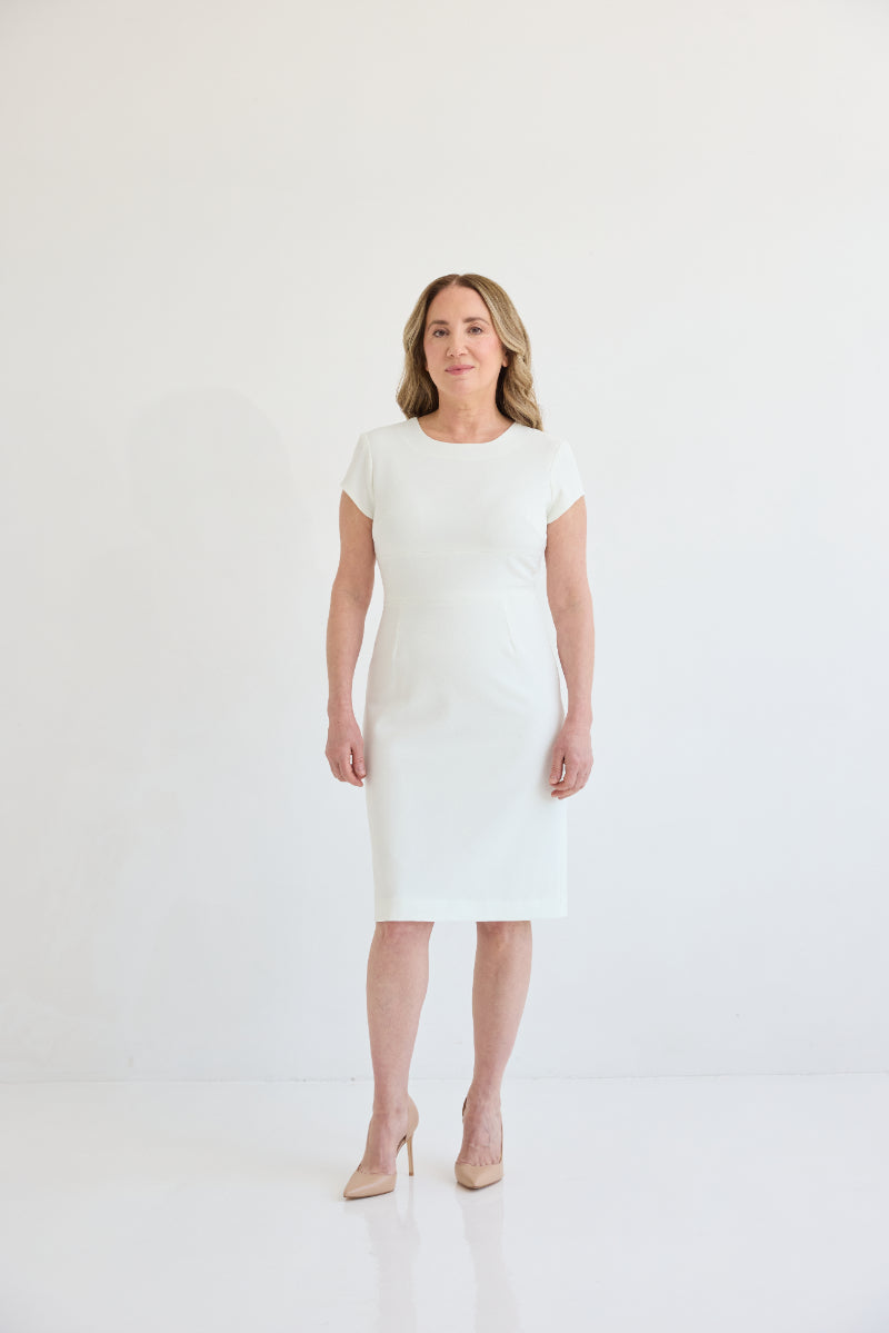 The Monroe Dress, Dress with jewel style neckline, cap sleeves, knee length, and back slit for ample movement. Dress in color white. 